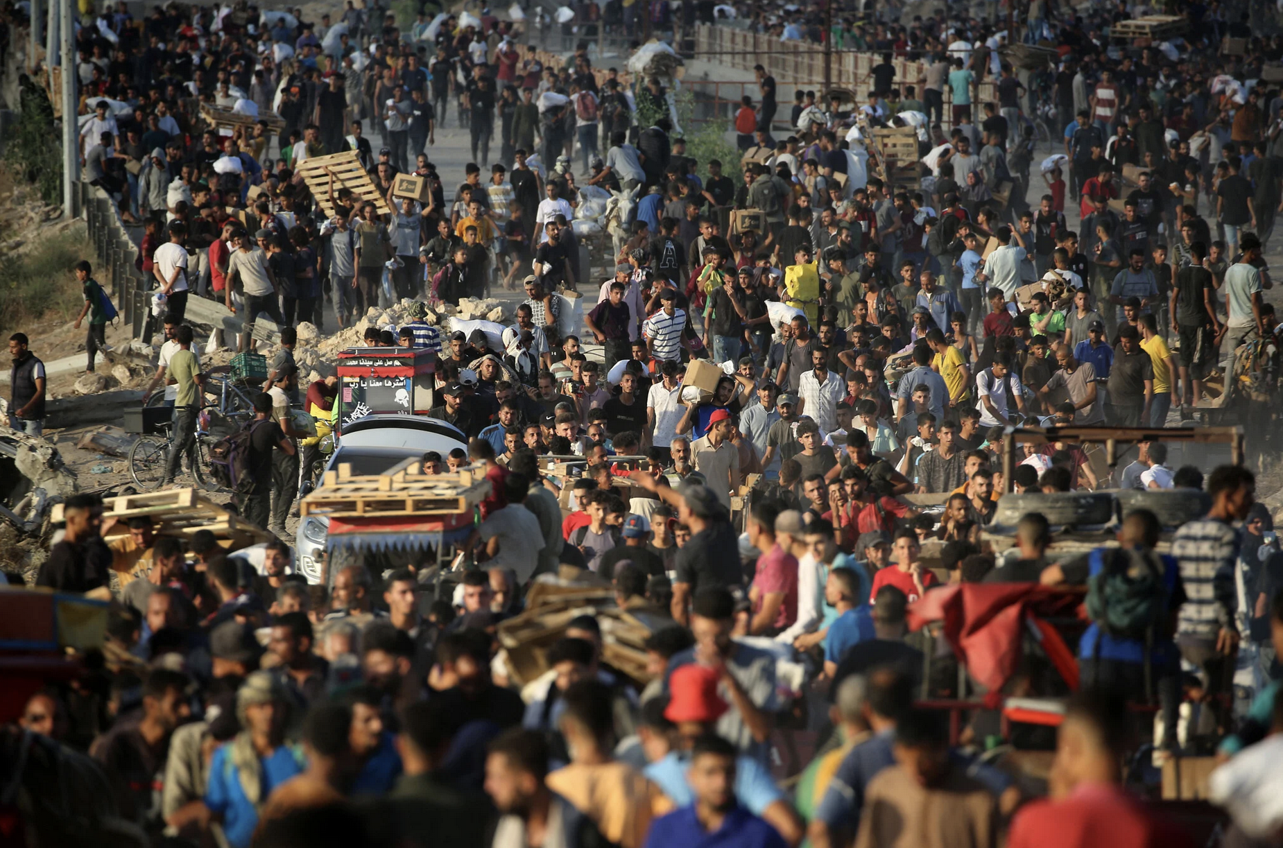 Palestinians gather at an aid distribution point set up by the privately-run Gaza Humanitarian Foundation (GHF), near the Nuseirat refugee camp in the central Gaza Strip on June 25, 2025. (Eyad BABA / AFP)