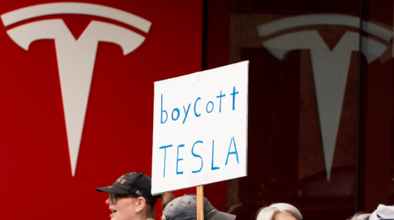 Sign reading 'Boycott Tesla'